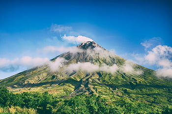 Stunning view of Mayon Volcano surrounded by blue skies and clouds in Bicol, Philippines. HD wallpaper