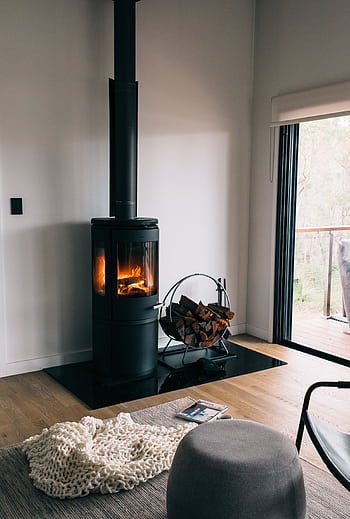 A cozy modern living room with a stylish fireplace and wood accents. HD phone wallpaper
