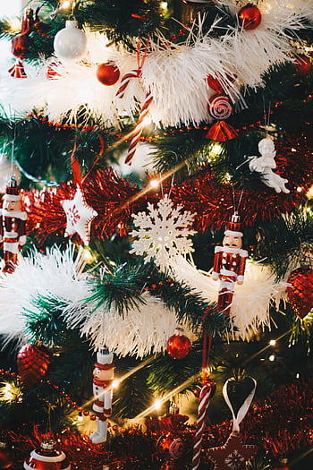 A festive Christmas tree adorned with colorful ornaments and sparkling lights. HD phone wallpaper