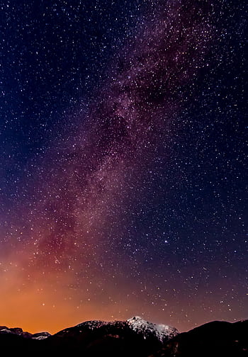 A breathtaking view of the Milky Way captured over a mountain range during a clear night. HD phone wallpaper