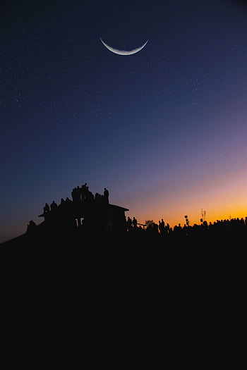 Silhouette of people under a crescent moon and starry twilight sky, evoking a serene evening view. HD phone wallpaper