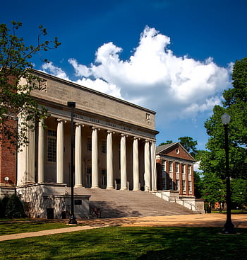 Historic neoclassical university library with columns on a sunny day. HD phone wallpaper