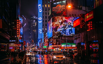 Bustling Times Square street scene in New York City, illuminated by vibrant neon lights and advertisements. HD wallpaper