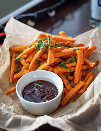 Appetizing sweet potato fries served with a rich dipping sauce, garnished with fresh herbs. HD phone wallpaper