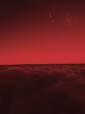 Capture the essence of a stunning red sky above rolling clouds at sunset, exuding warmth and drama. HD phone wallpaper