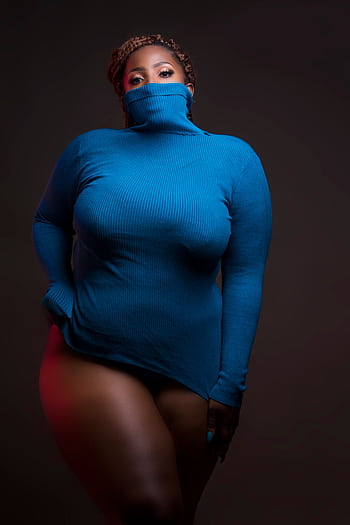 Striking studio portrait of a woman posing confidently in a blue sweater. HD phone wallpaper