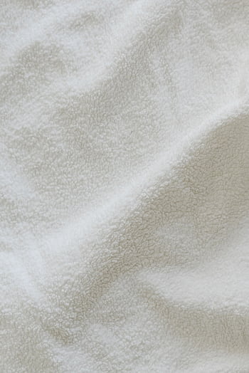 Close-up of a crumpled white terry cloth showcasing soft textile texture. HD phone wallpaper