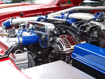 Detailed view of a clean modern car engine with vibrant colored components and sleek design. HD wallpaper