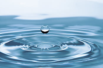 A mesmerizing shot of a water droplet capturing the beauty of liquid dynamics. HD wallpaper
