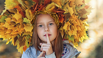 Cute Little Girl Is Wearing Light Ash Dress Having Finger On Mouth Having Colorful Autumn Leaves Wreath On Head Cute HD wallpaper