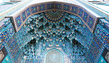 A close-up view of an ornate Islamic dome with vibrant blue mosaic patterns and geometric design. HD wallpaper