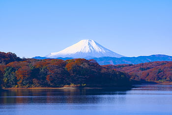 Breathtaking autumn view of Mount Fuji with calm lake and colorful trees reflecting clear sky. HD wallpaper