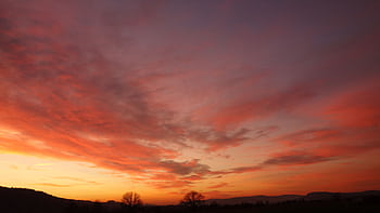 A breathtaking sunset with vivid colors over a peaceful landscape, capturing nature's beauty at dusk. HD wallpaper