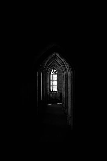 A captivating gothic archway leading to a faintly lit window, creating an eerie and mysterious atmosphere. HD phone wallpaper
