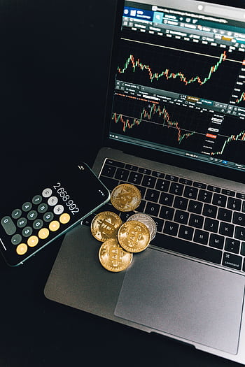 A still life of Bitcoin coins, a smart calculator, and a trading chart on a laptop. HD phone wallpaper