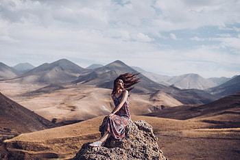 Girl Sitting On Rock Hairs In Air, girls, graphy, rock HD wallpaper