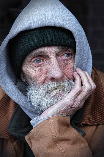 Portrait of an elderly man in a hoodie, capturing the essence of thought and introspection. HD phone wallpaper