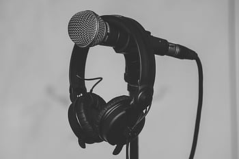 Black and white close-up of a micro and heads on a stand, perfect for music and recording studio themes. HD wallpaper