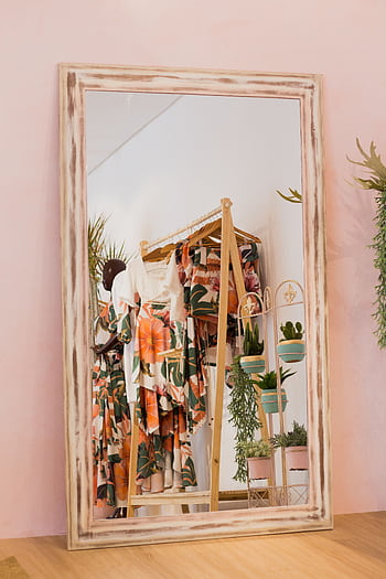 Stylish floral dresses reflected in a boutique mirror with indoor plants. HD phone wallpaper