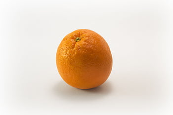 A single fresh orange isolated on a white background, symbolizing health and freshness. HD wallpaper