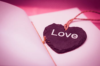 A heart-shaped slate with 'Love' written on it, symbolizing romance and affection. HD wallpaper