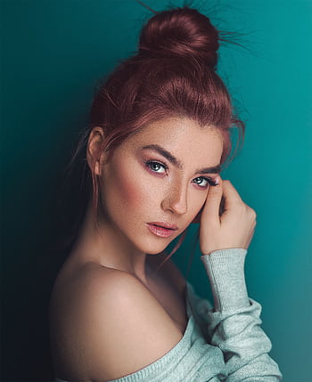 A fashionable adult woman posing with elegant makeup against a teal background. HD phone wallpaper