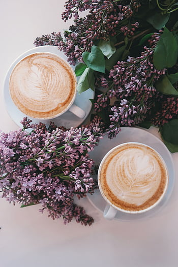 Artistic latte art surrounded by blooming lilac flowers creates a cozy, aesthetic vibe. HD phone wallpaper