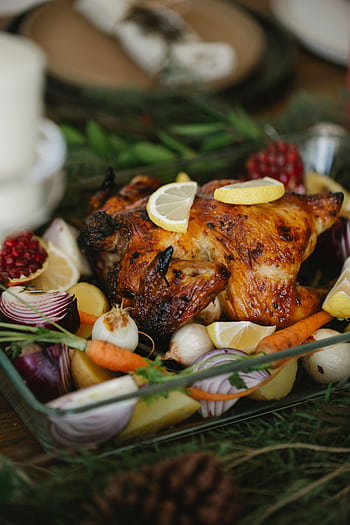 Delicious roast chicken surrounded by fresh vegetables, perfect for a holiday feast. HD phone wallpaper