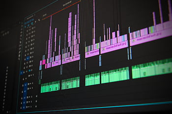 Close-up of a professional audio and video editing software interface with waveform displays. HD wallpaper