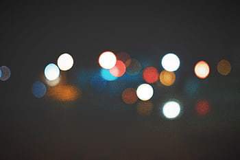 An artistic bokeh effect of colorful city lights creating a soft, dreamy atmosphere. HD wallpaper