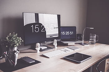 Organized desk setup with monitors, laptop, and office accessories for productivity. HD wallpaper