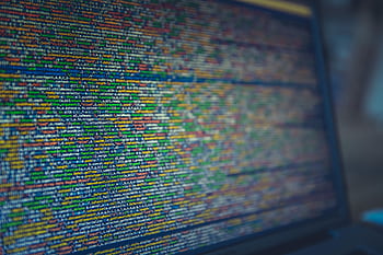 A detailed view of colorful source code displayed on a computer screen, representing modern programming and technology. HD wallpaper