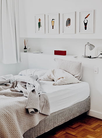 Contemporary bedroom design featuring art prints and cozy bedding for a warm ambiance. HD phone wallpaper