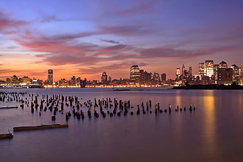 Cities, Rivers, Sunset, Sky, Lilac, Clouds, Usa, Lights, Wooden, Skyscrapers, Backlight, Illumination, Evening, United States, Pillars, Jersey City, State Of New Jersey, New Jersey State, Hudson, Columns HD wallpaper