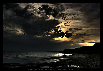 The Isle of Wight UK, sea, black, silhoutte, coast, rocks, stones, yellow, clouds, sky HD wallpaper