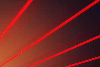 Abstract with vibrant red laser beams on a dark gradient backdrop, illustrating futuristic design. HD wallpaper