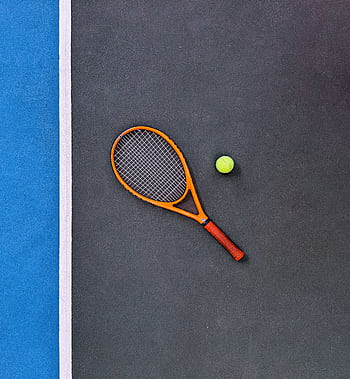 A tennis racket and ball on a court, emphasizing sports equipment essentials. HD phone wallpaper