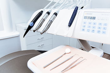 Clean and professional dental office setup with tools ready for patient treatment. HD wallpaper