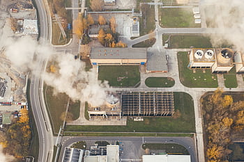 Aerial shot of an industrial area with visible smoke emissions in Poznań, Poland. HD wallpaper