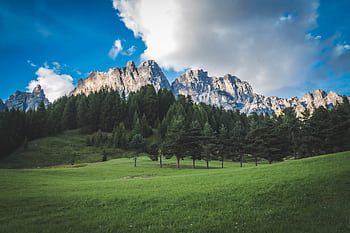 Scenic view of Dolomite peaks with lush green meadow in Rocca Pietore, Italy. HD wallpaper