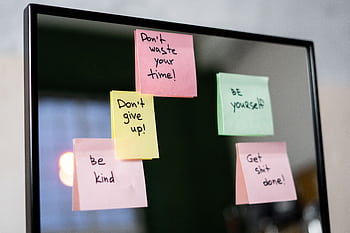 Colorful sticky notes with motivational messages on a mirror reflecting positivity. HD wallpaper