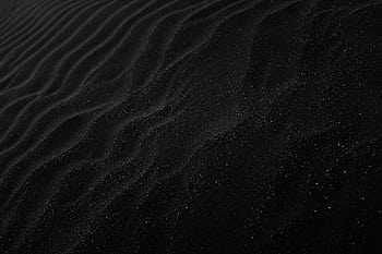 Textured black sand with ripples resembling dunes, creating a dark, abstract aesthetic. HD wallpaper