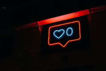 Bright neon heart icon with zero likes, symbolizing social media engagement. HD wallpaper