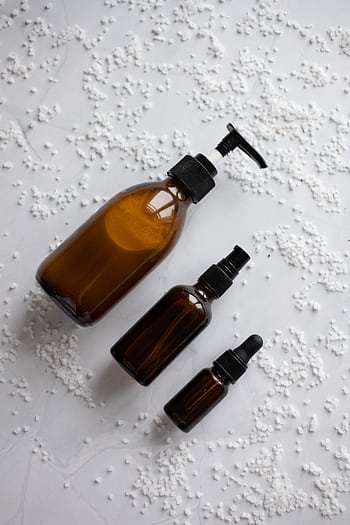 Minimalist skincare bottles arranged aesthetically on white background with bath salts. HD phone wallpaper