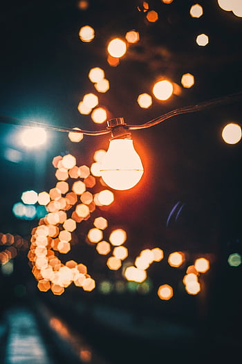 Captivating string lights with a bokeh effect, creating a warm and inviting night atmosphere. HD phone wallpaper