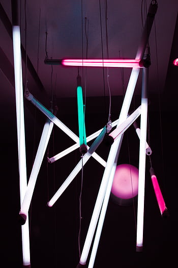 Abstract arrangement of bright neon lights hanging indoors, creating modern art ambiance. HD phone wallpaper