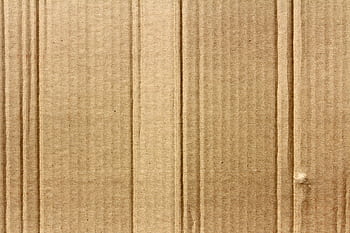 Detailed texture of brown corrugated cardboard, ideal for backgrounds. HD wallpaper