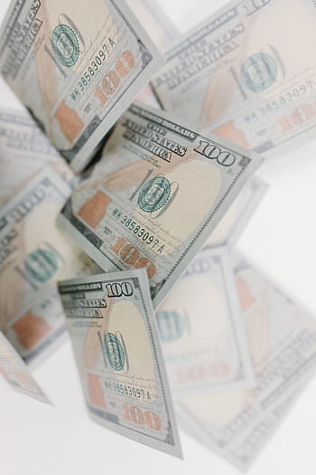 A collection of 100 dollar bills floating against a white background, emphasizing wealth and finance. HD phone wallpaper