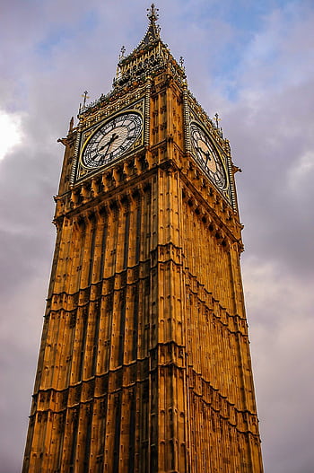 Close-up view of the iconic Elizabeth Tower, featuring the world-famous clock, in London, United Kingdom. HD phone wallpaper