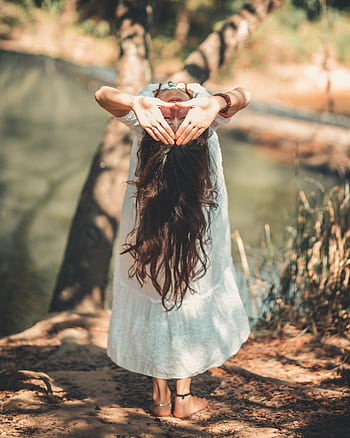 A woman with long hair performing a yoga pose by a tranquil river in a sunny outdoor setting. HD phone wallpaper